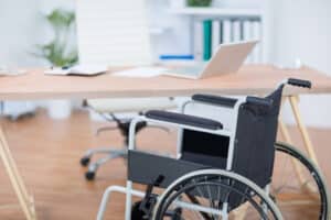 a free wheelchair at his desk in the office 2025 04 05 00 11 18 utc